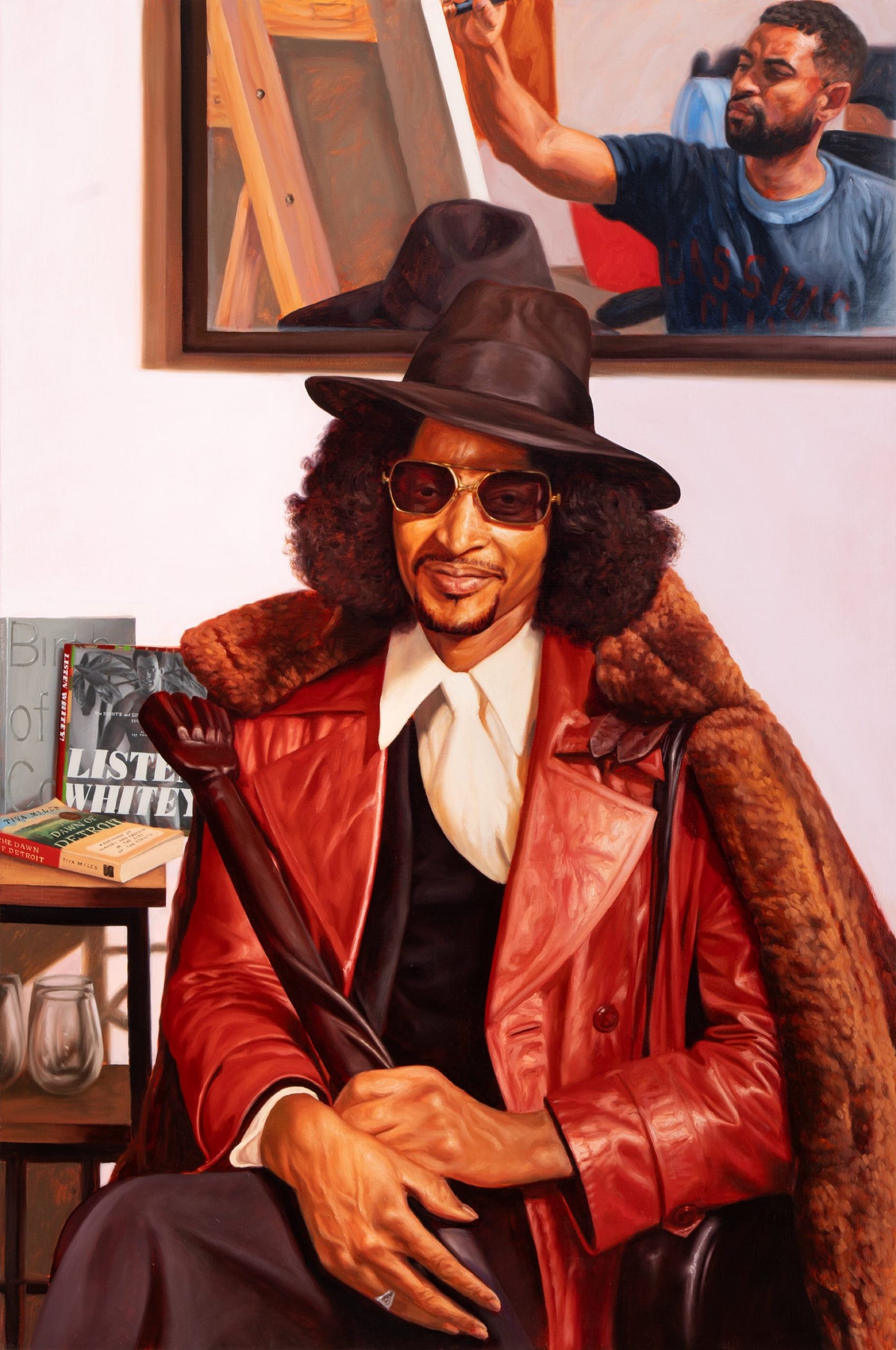 an oil portrait of a Black man with a hat and leather jacket, seated and looking at the viewer in front of a mirror depicting the artist working on the painting