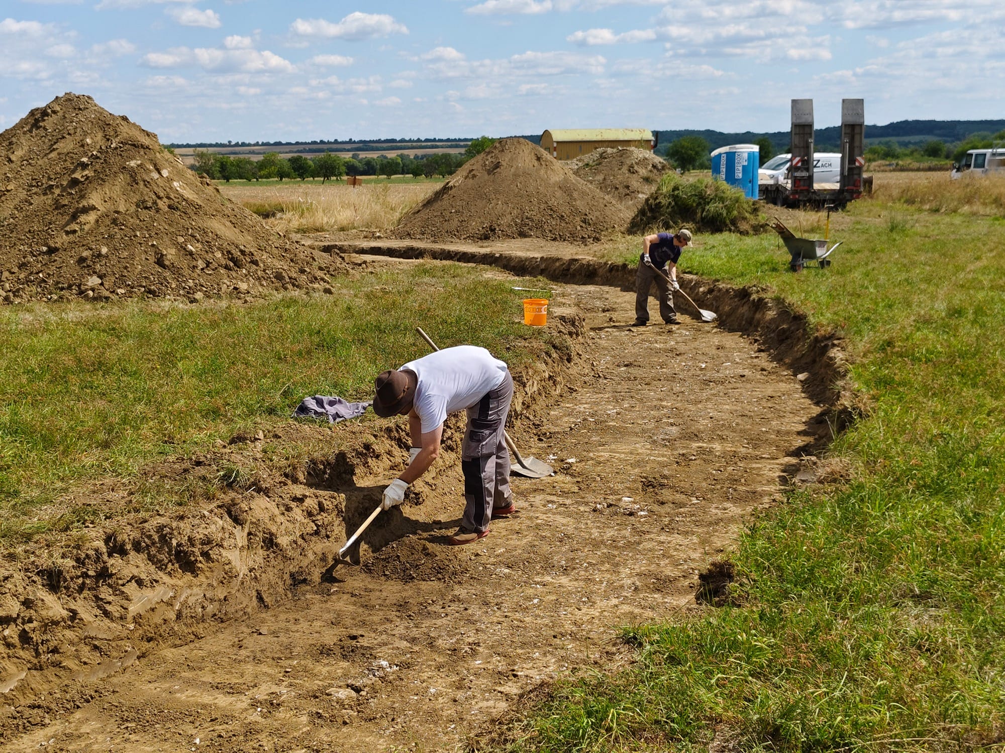 people working on a grassy earthwork