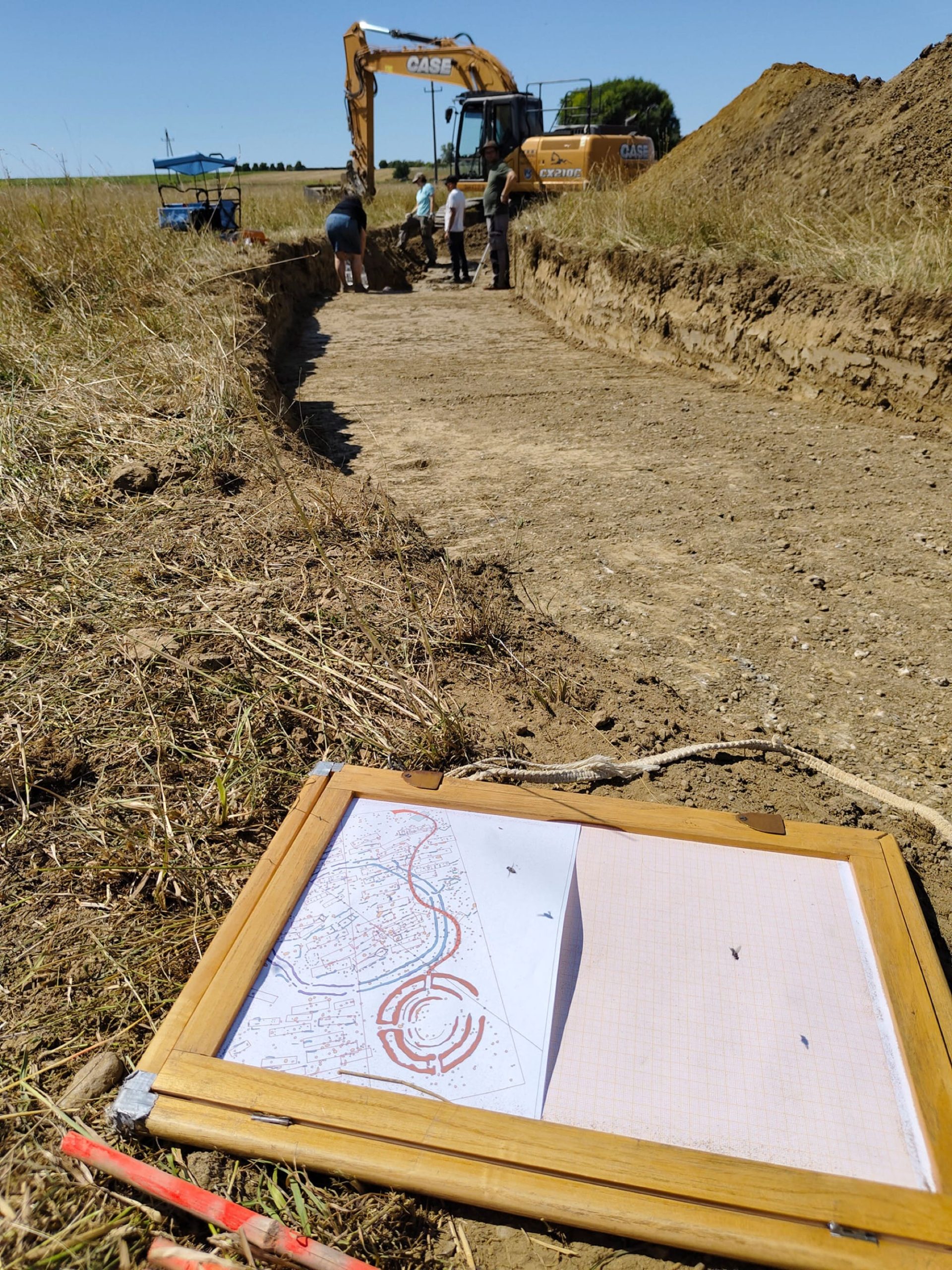 a drawing and excavation of a grassy earthwork