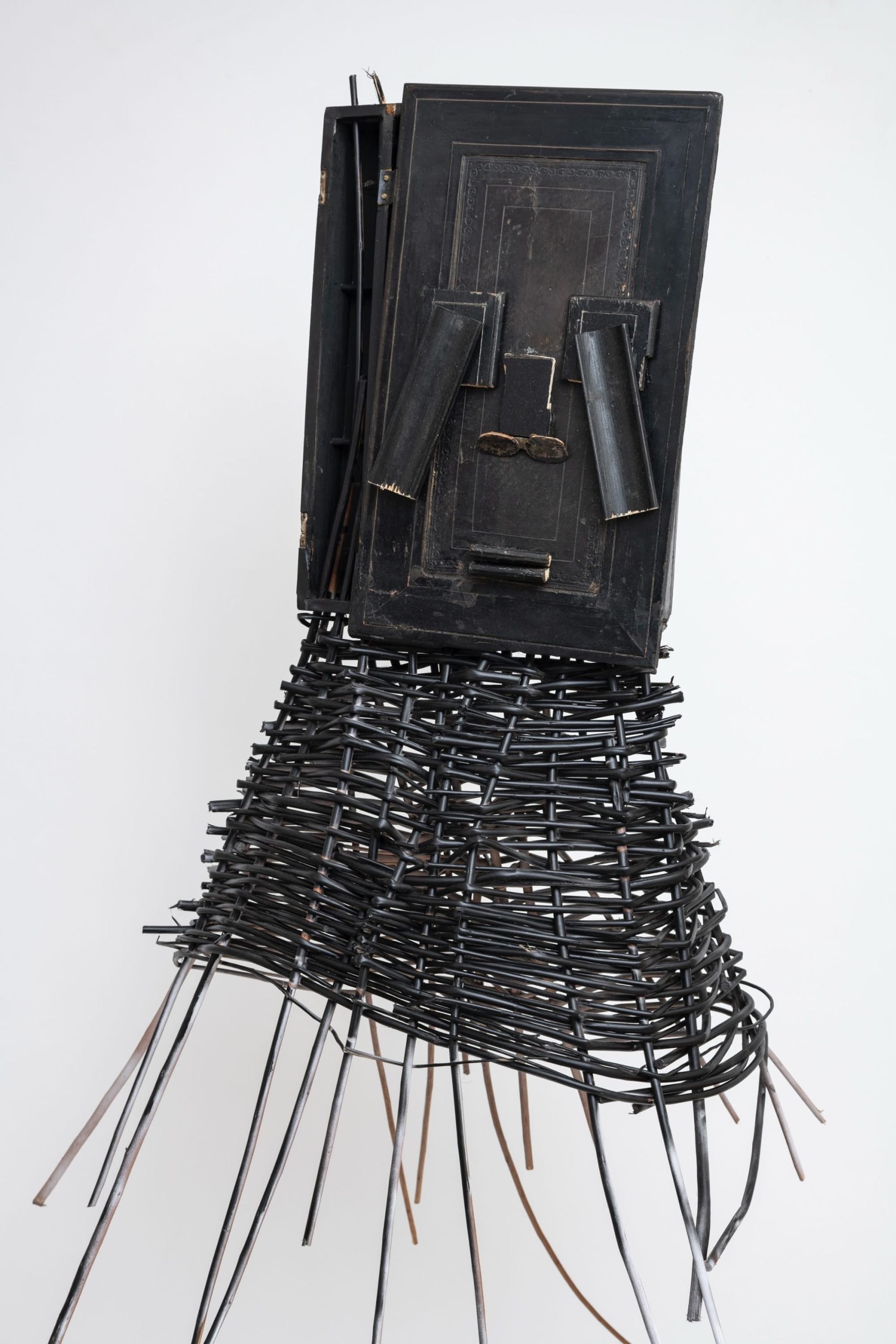 a sculptural mask inspired by African ceremonial masks, made from a colonial-era writing desk