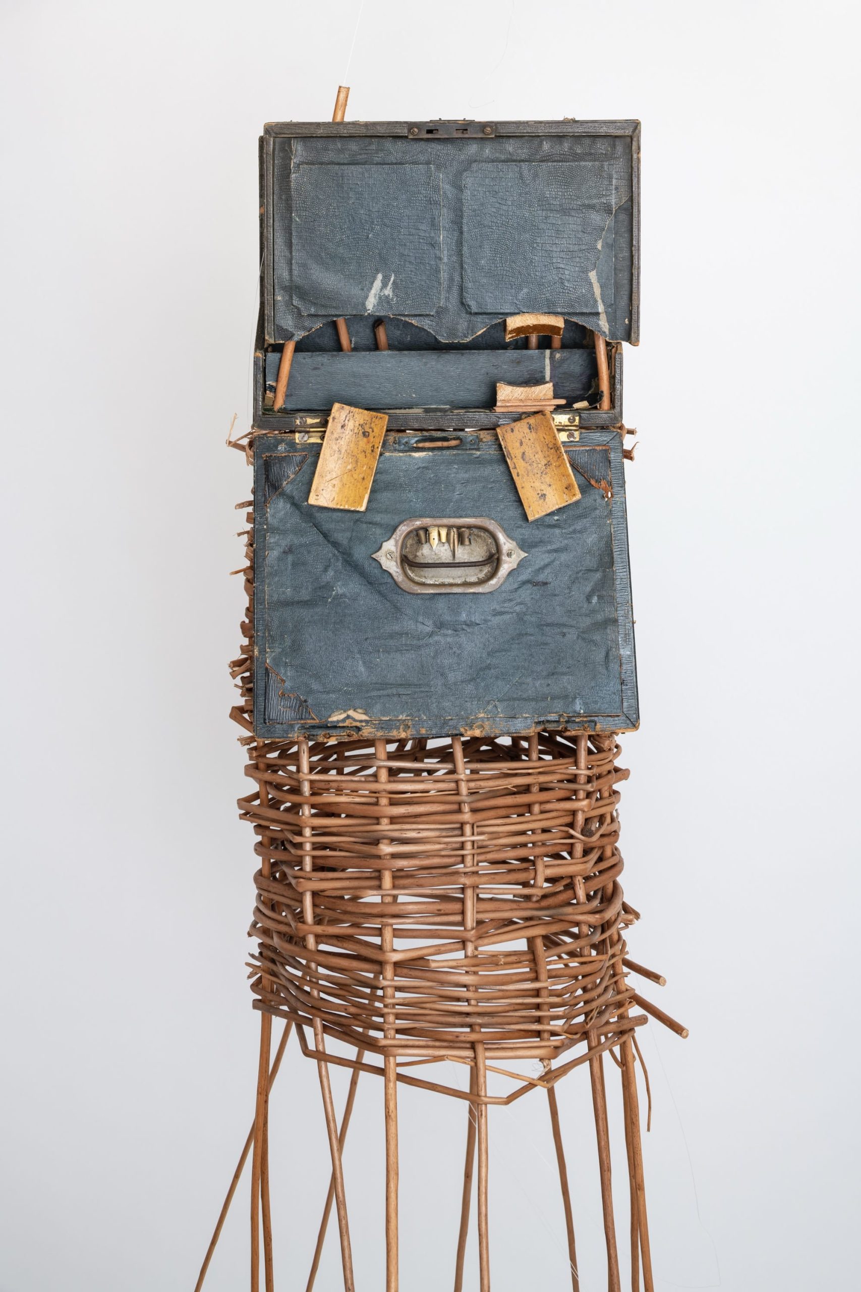 a sculptural mask inspired by African ceremonial masks, made from a colonial-era writing desk