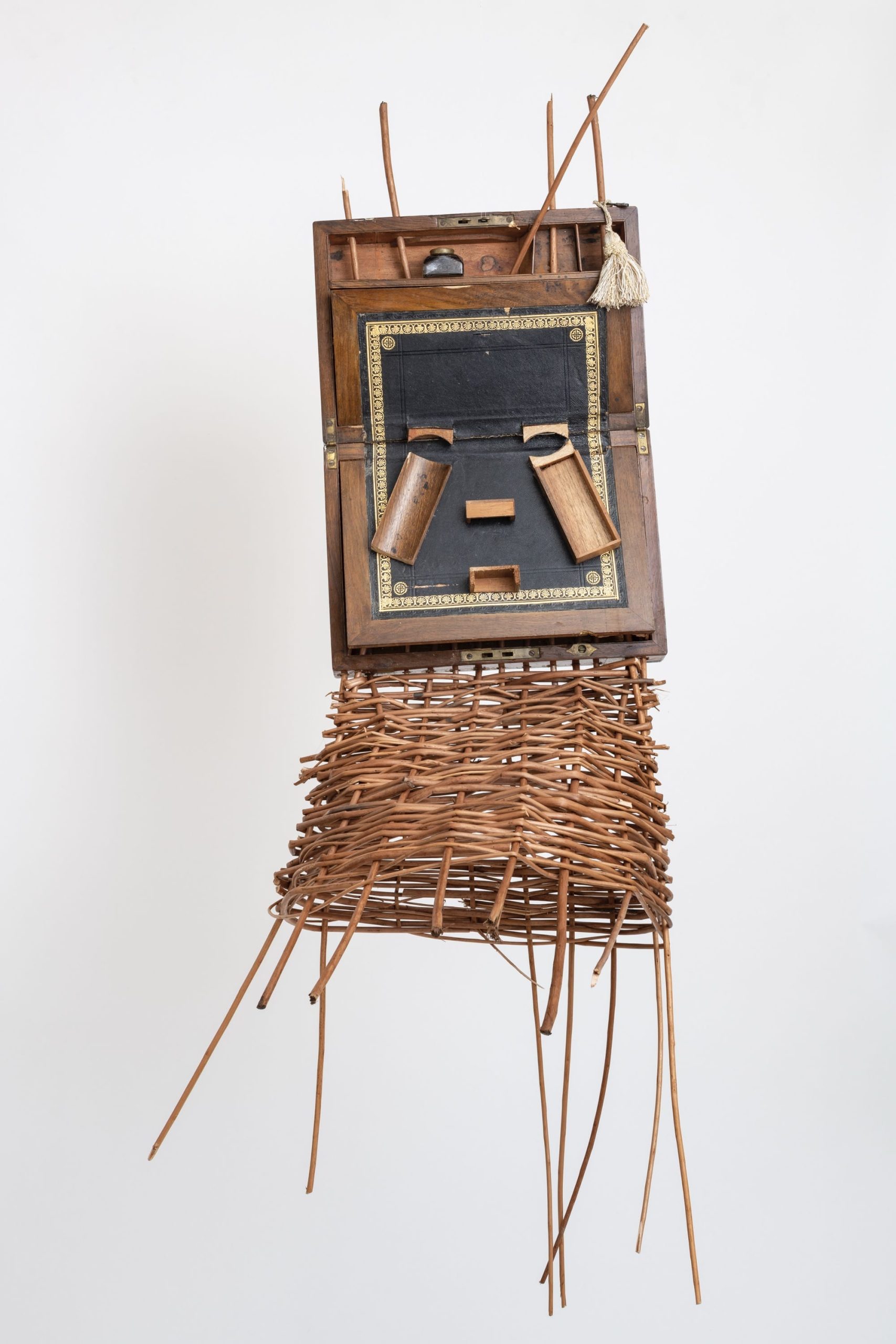 a sculptural mask inspired by African ceremonial masks, made from a colonial-era writing desk