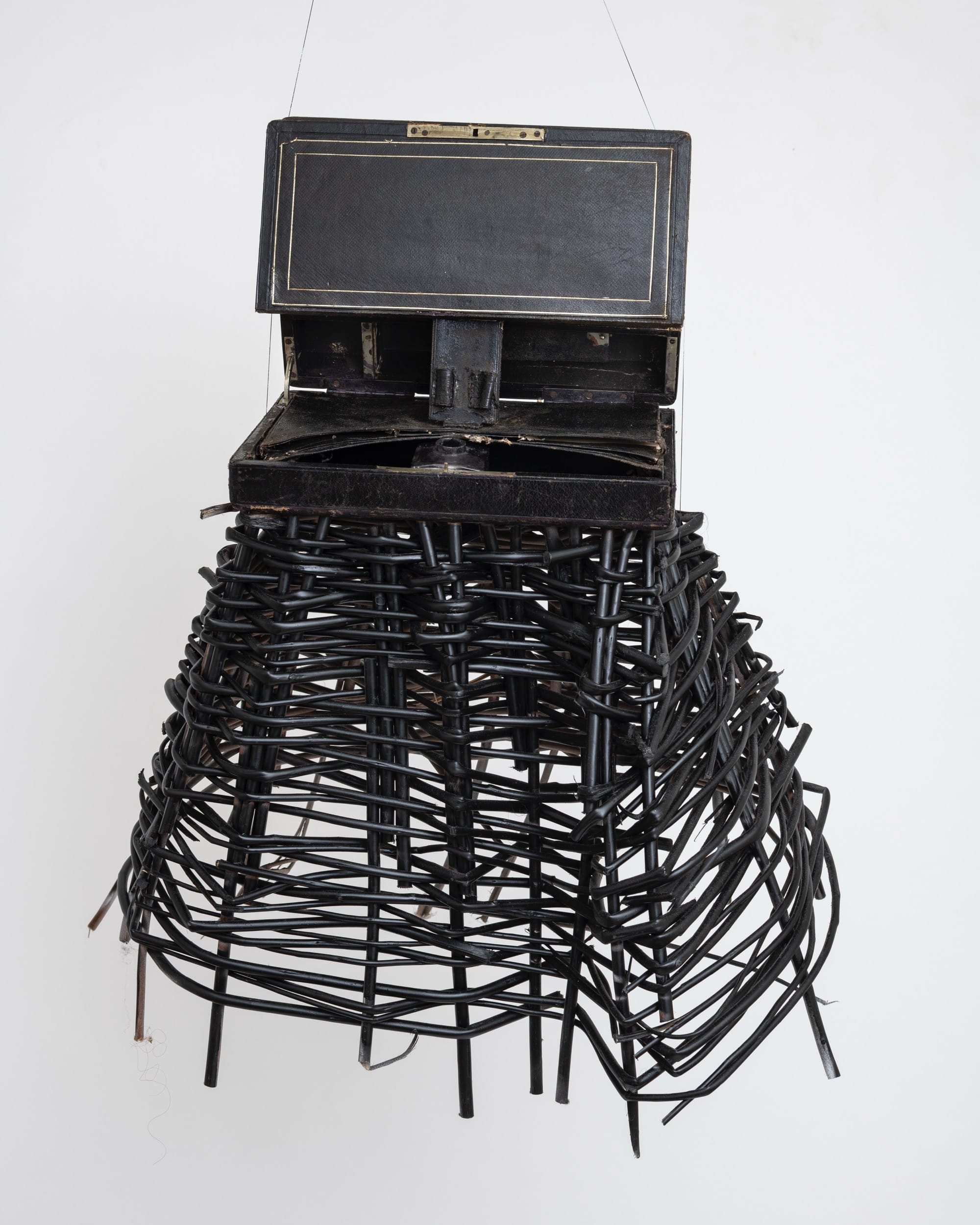 a sculptural mask inspired by African ceremonial masks, made from a colonial-era writing desk