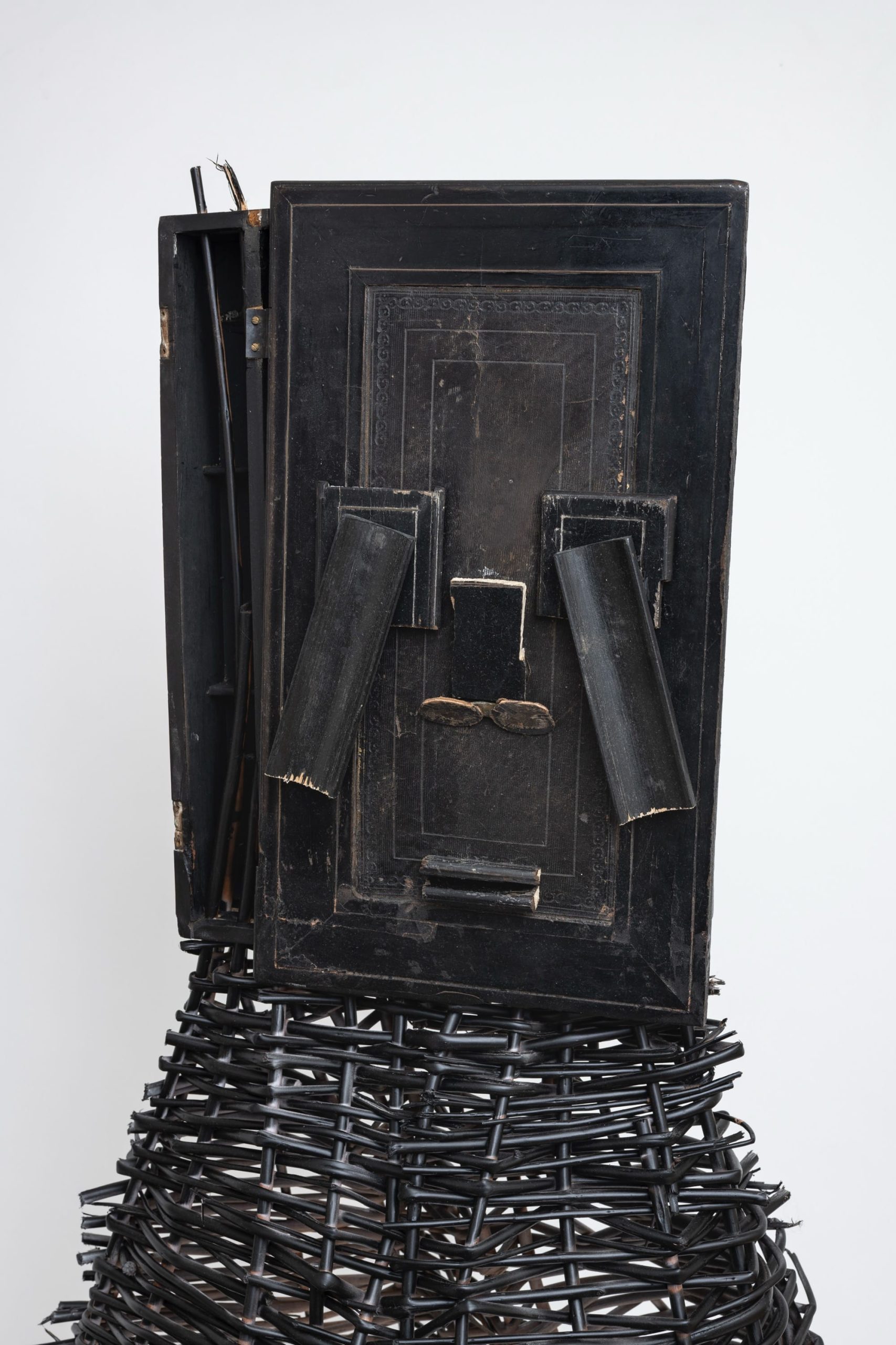 a sculptural mask inspired by African ceremonial masks, made from a colonial-era writing desk